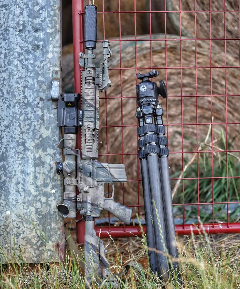 Rifle with TBAC can leaning at truck bumper