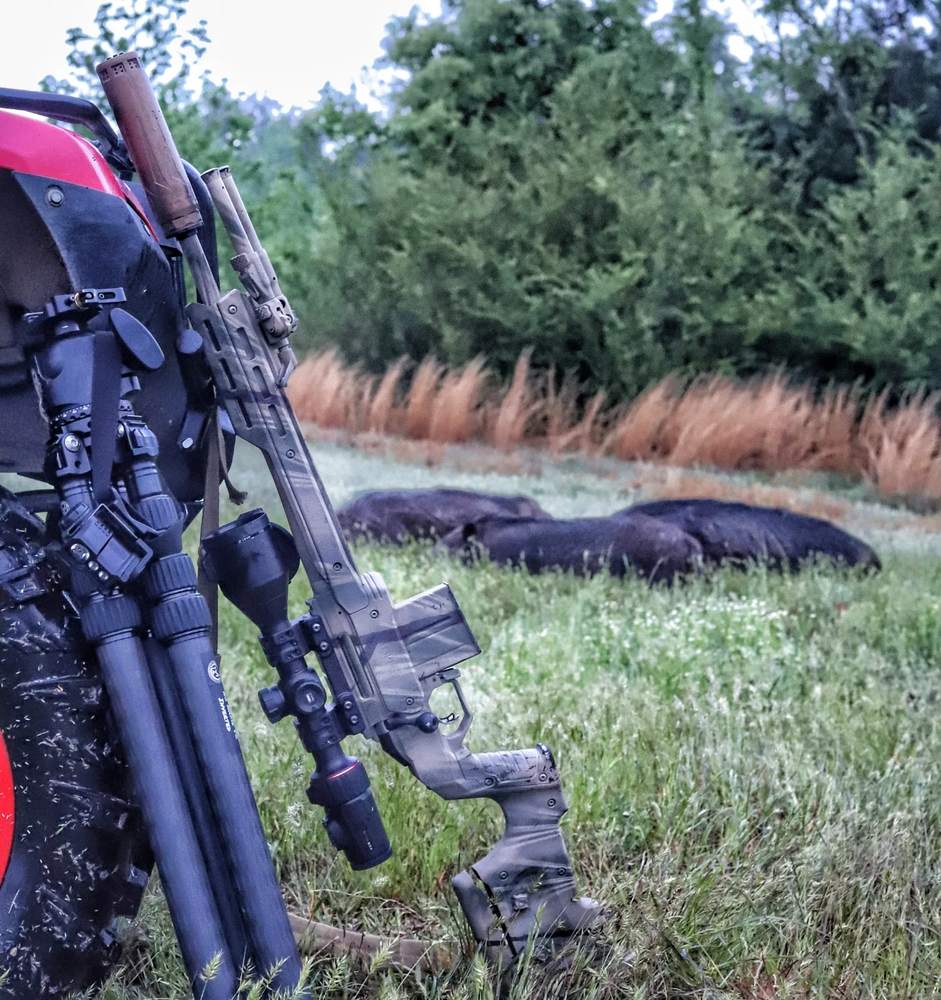 Bolt gun and gear against ATV on a morning hunt