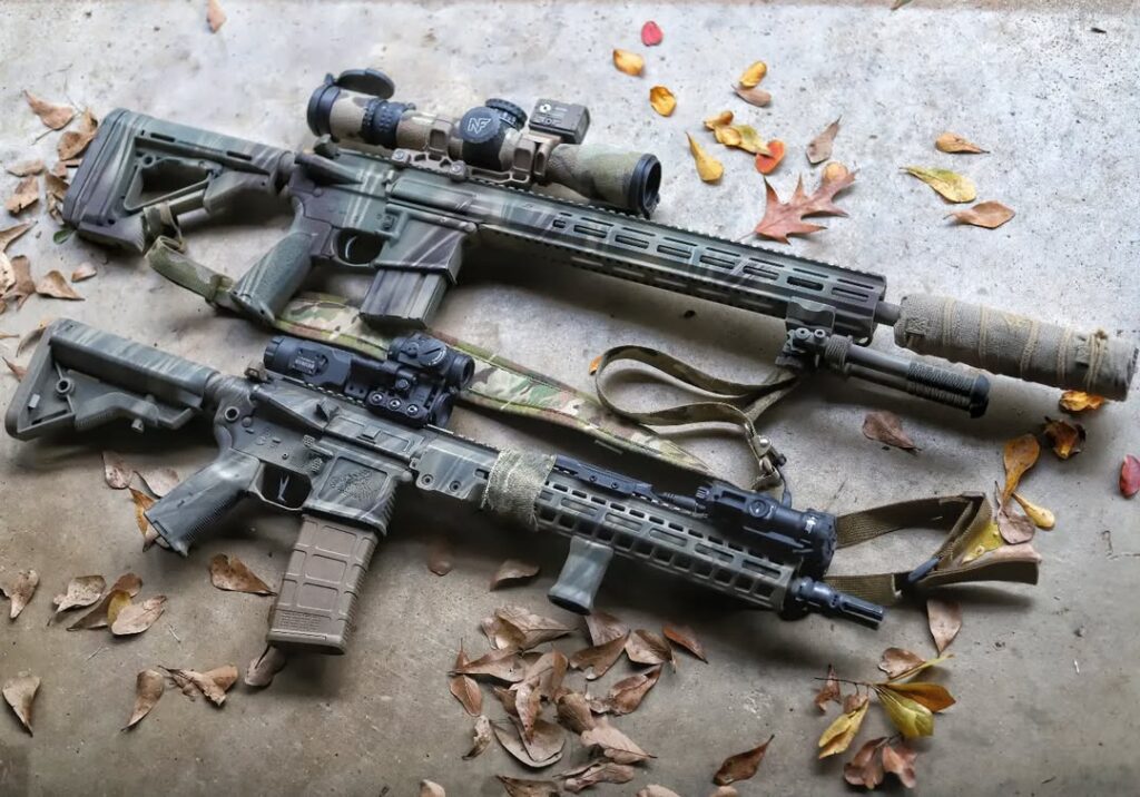Two rifles spray painted with Rogue Texan's Rogue Camo pattern